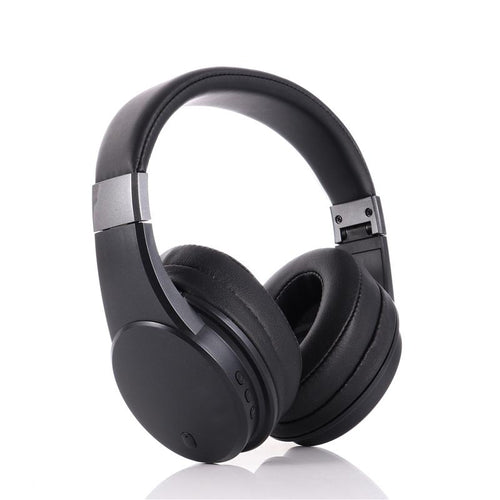Black over-ear wireless headphones with padded ear cups and a padded headband, shown at an angle on a white background with a faint reflection below.